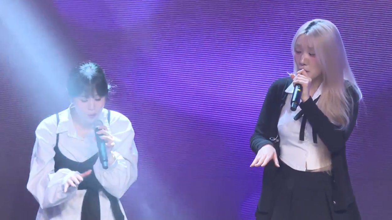 온맘씨어터 프리즘 미니콘서트 — 보라색 조명 아래 두 출연자가 함께 부르는 듀엣 무대