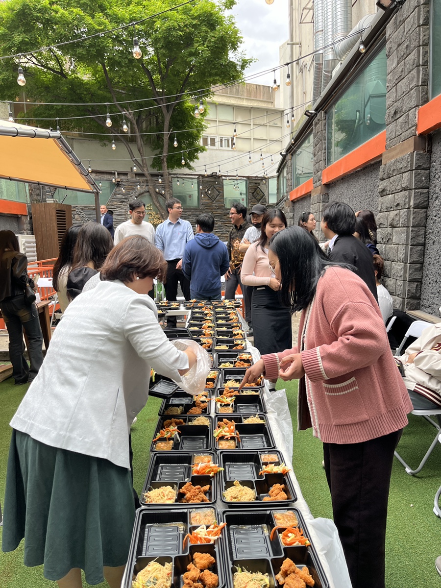 예배 후 온맘씨어터 1층 공용 라운지 잔디마당에 차려진 인도네시아 음식 도시락과 식사를 받는 성도들